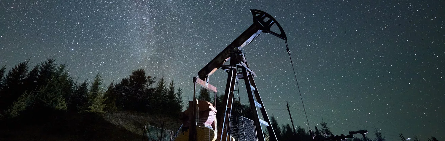 an onshore oil rig against a starry night, oil and gas specialty support