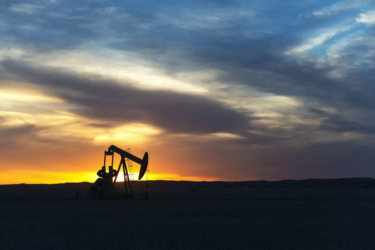 Oilfield pumpjack,Canada,A pumpjack at an oil drilling site at sunset.
