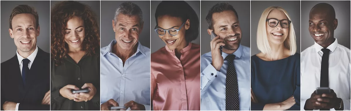 Diverse group of smiling businesspeople using cellphones