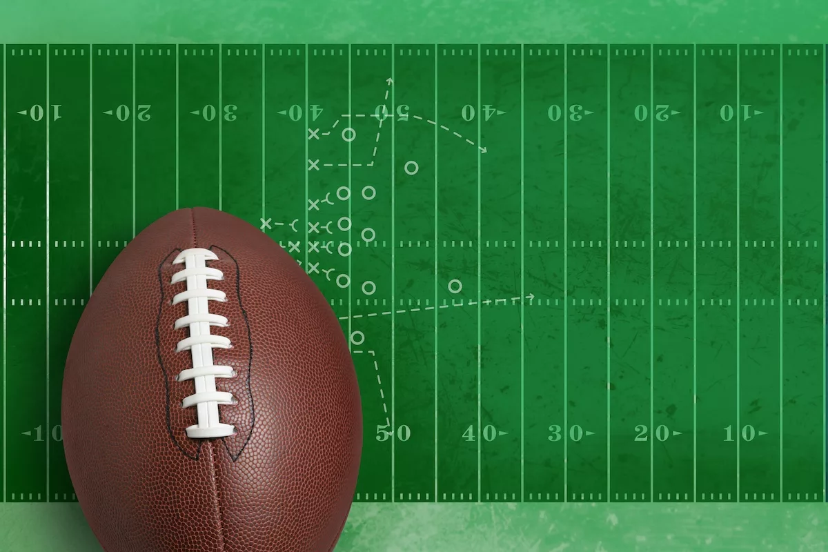 Football superimposed on a textured field with diagram of play