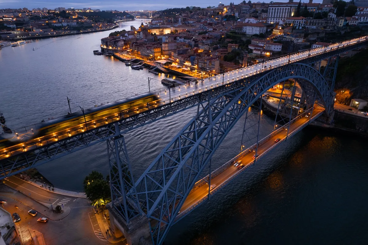 Illuminated bridge over river in city