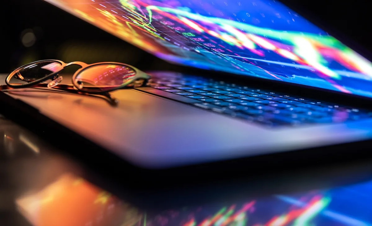 the glow of a laptop screen shows digital transformation